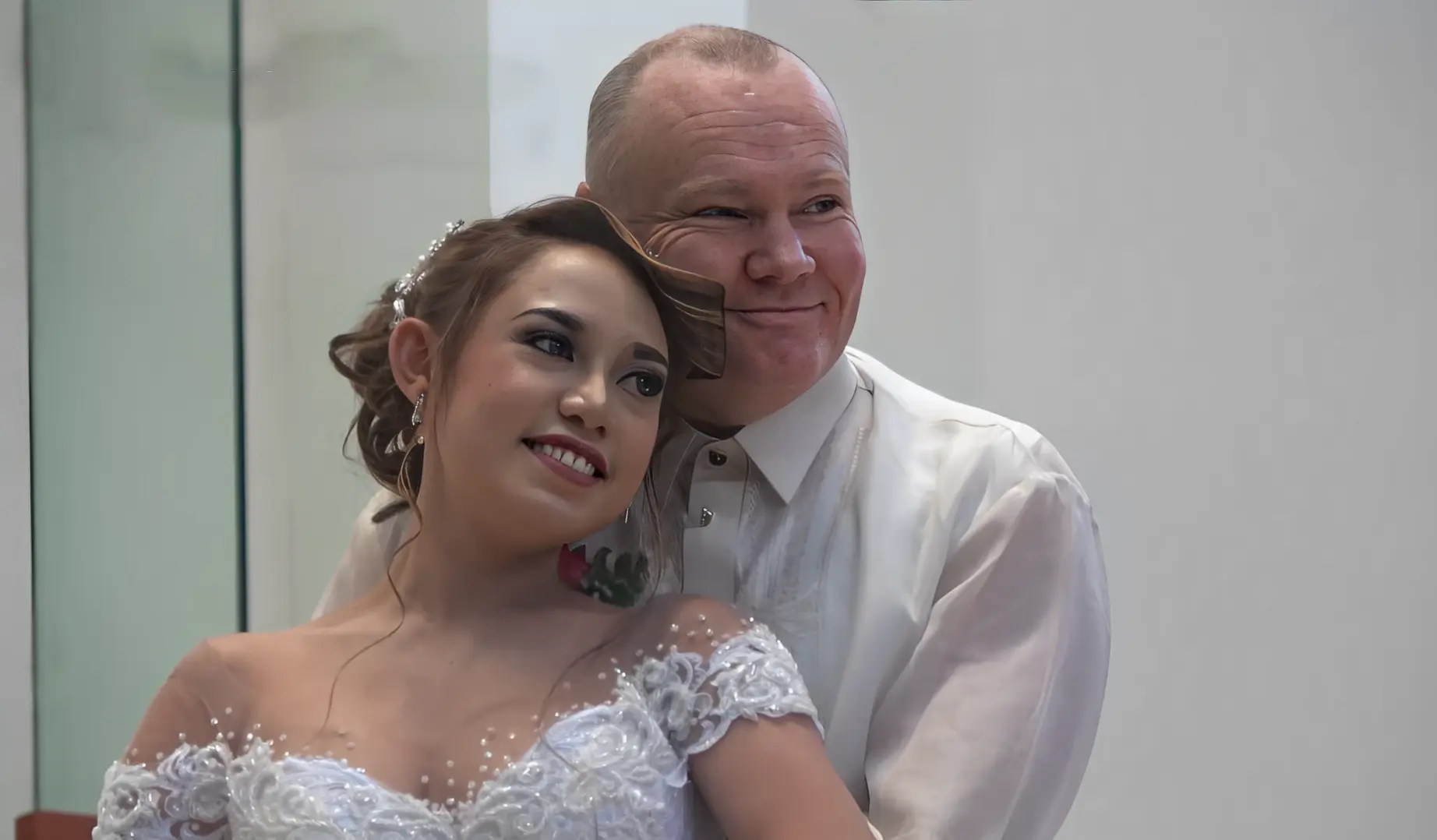 newly-wed couple is happily facing on the camera