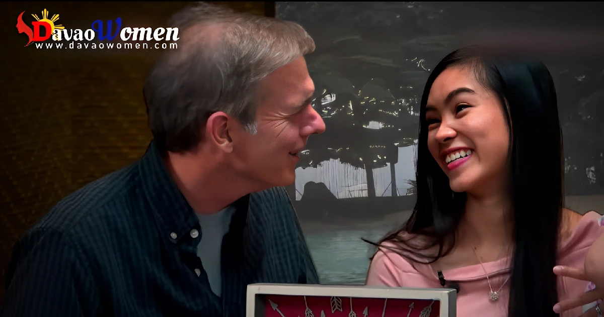 a foreign man and a filipina women smiling at each other