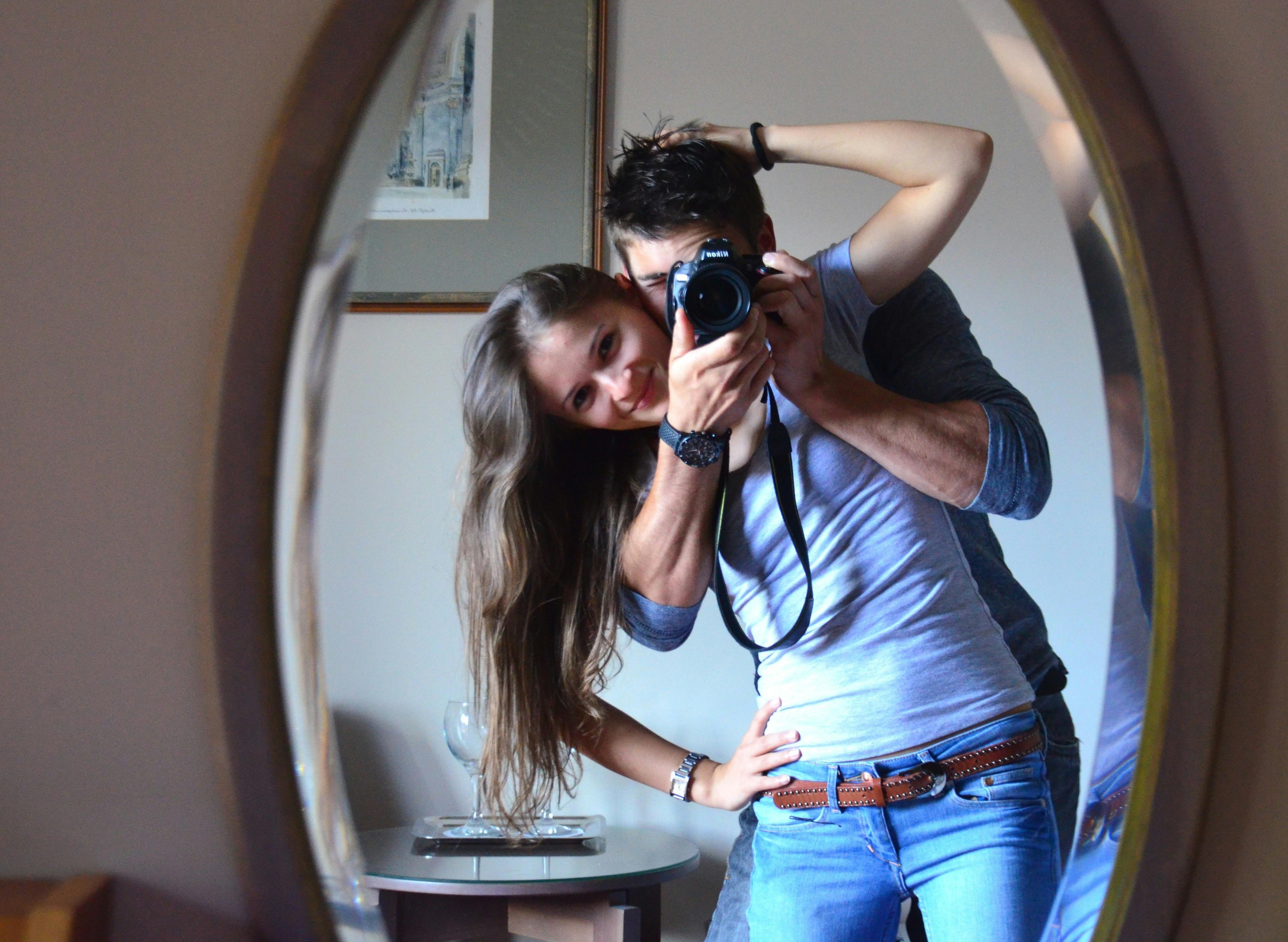 A couple taking a mirror picture.