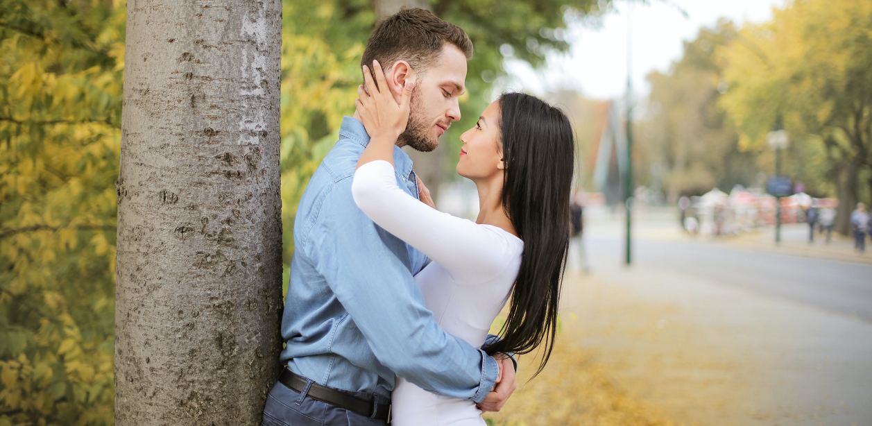 A couple lovingly staring at each other's eyes.